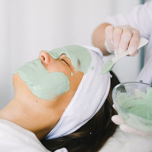 woman receiving a facial at a spa